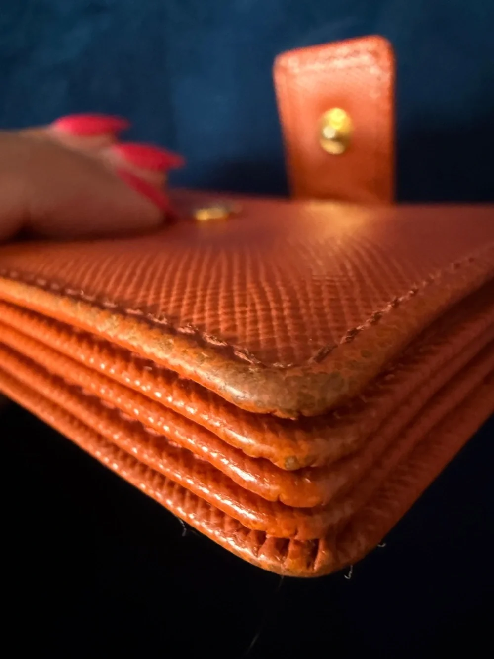 Orange Prada Saffiano Leather accordion card holder.